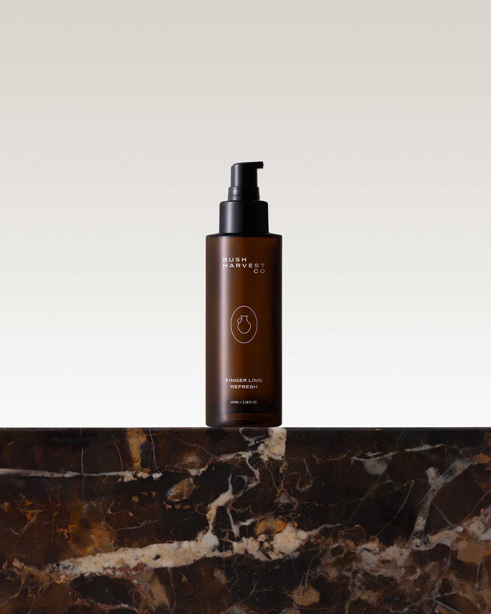 Image of Finger Lime Refresh Purifying Facial Cleanser on marble bench top.