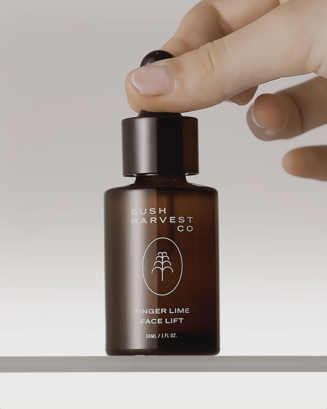 Video of hand using dropper to drop serum from Finger Lime Face Lift Hydrating & Brightening Serum bottle.